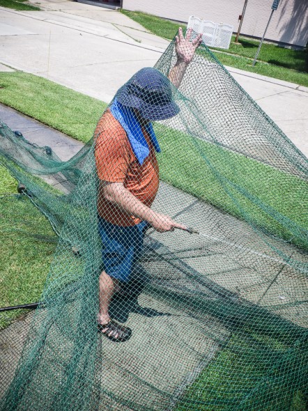 Rinsing the mud off a shrimp net